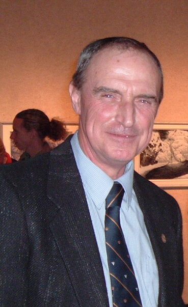 A photograph of Michael in suit and tie.